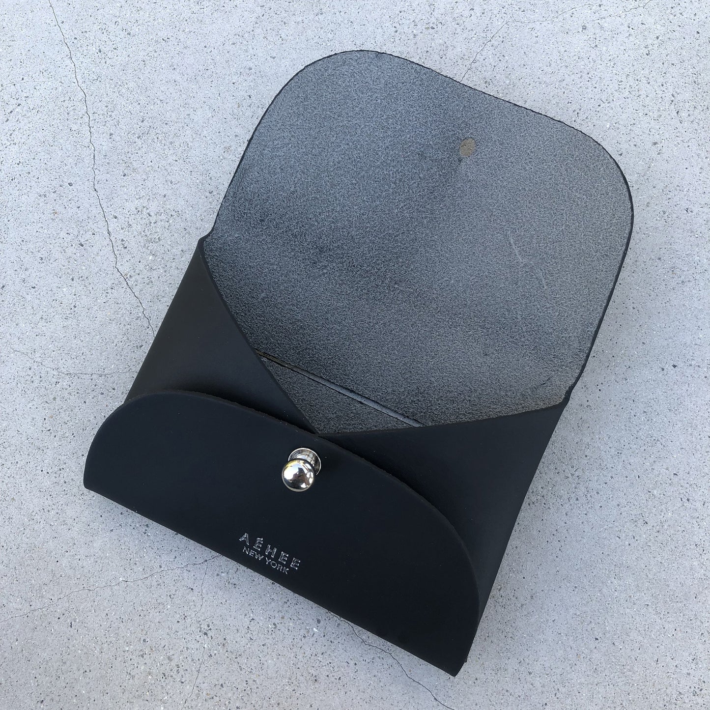 Chic black cardholder wallet crafted from Italian vegetable tanned leather for a minimal yet sophisticated look.