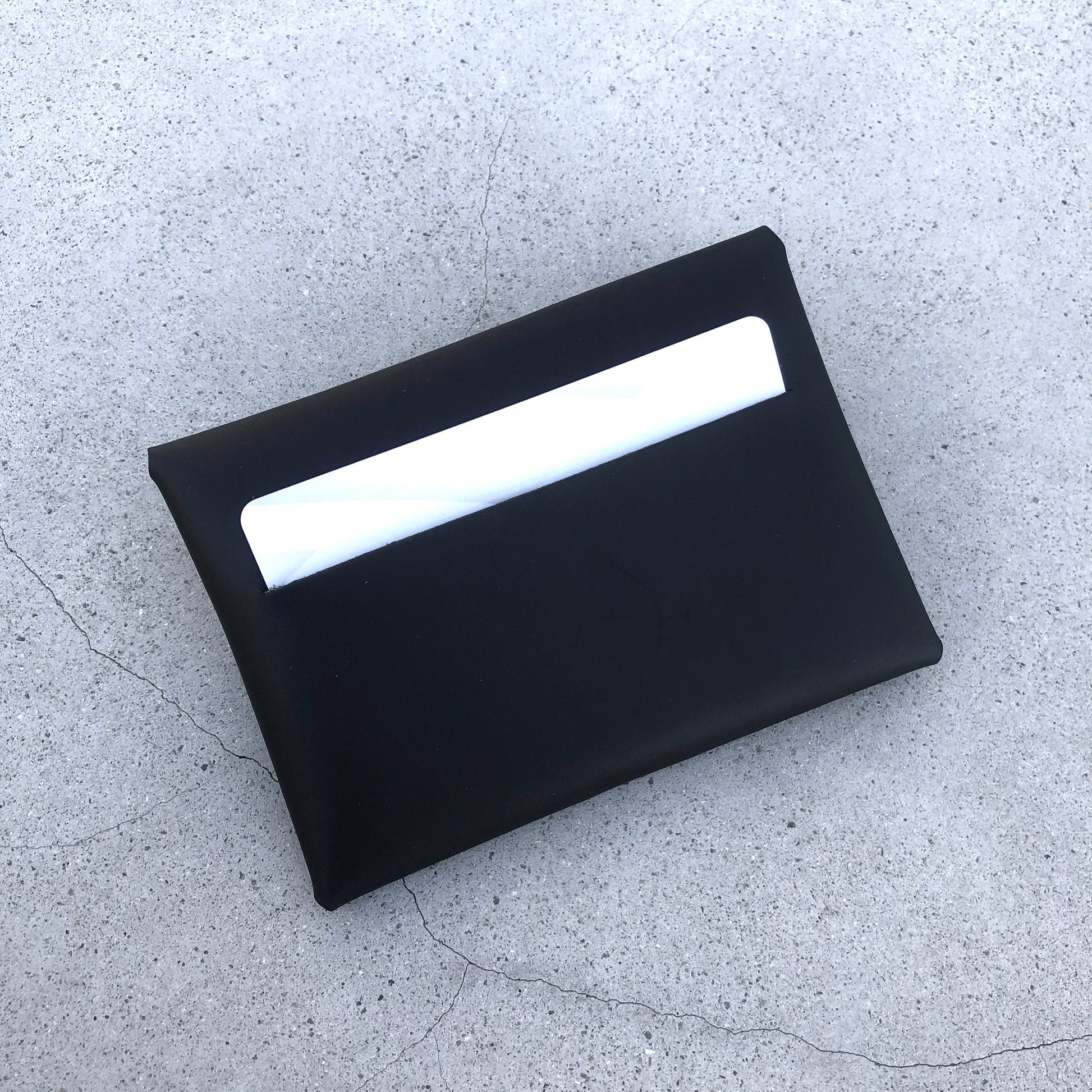 Chic black cardholder wallet crafted from Italian vegetable tanned leather for a minimal yet sophisticated look.