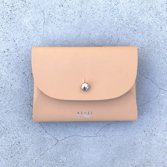 Chic beige cardholder wallet crafted from Italian vegetable tanned leather for a minimal yet sophisticated look.