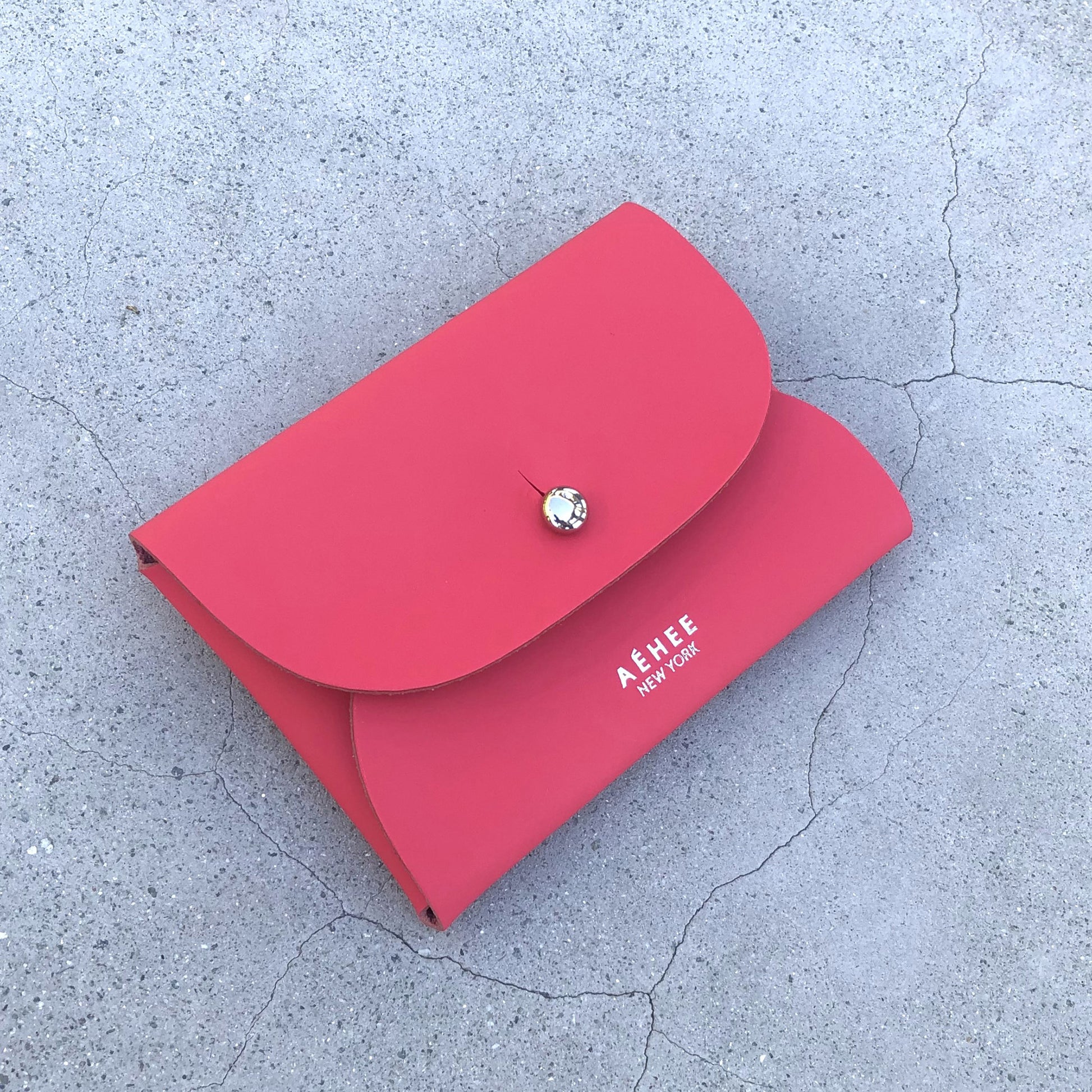 Chic red cardholder wallet crafted from Italian vegetable tanned leather for a minimal yet sophisticated look.