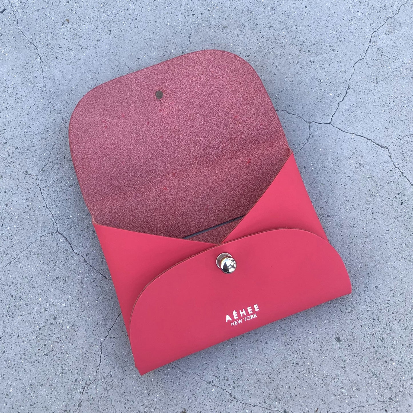 Chic red cardholder wallet crafted from Italian vegetable tanned leather for a minimal yet sophisticated look.