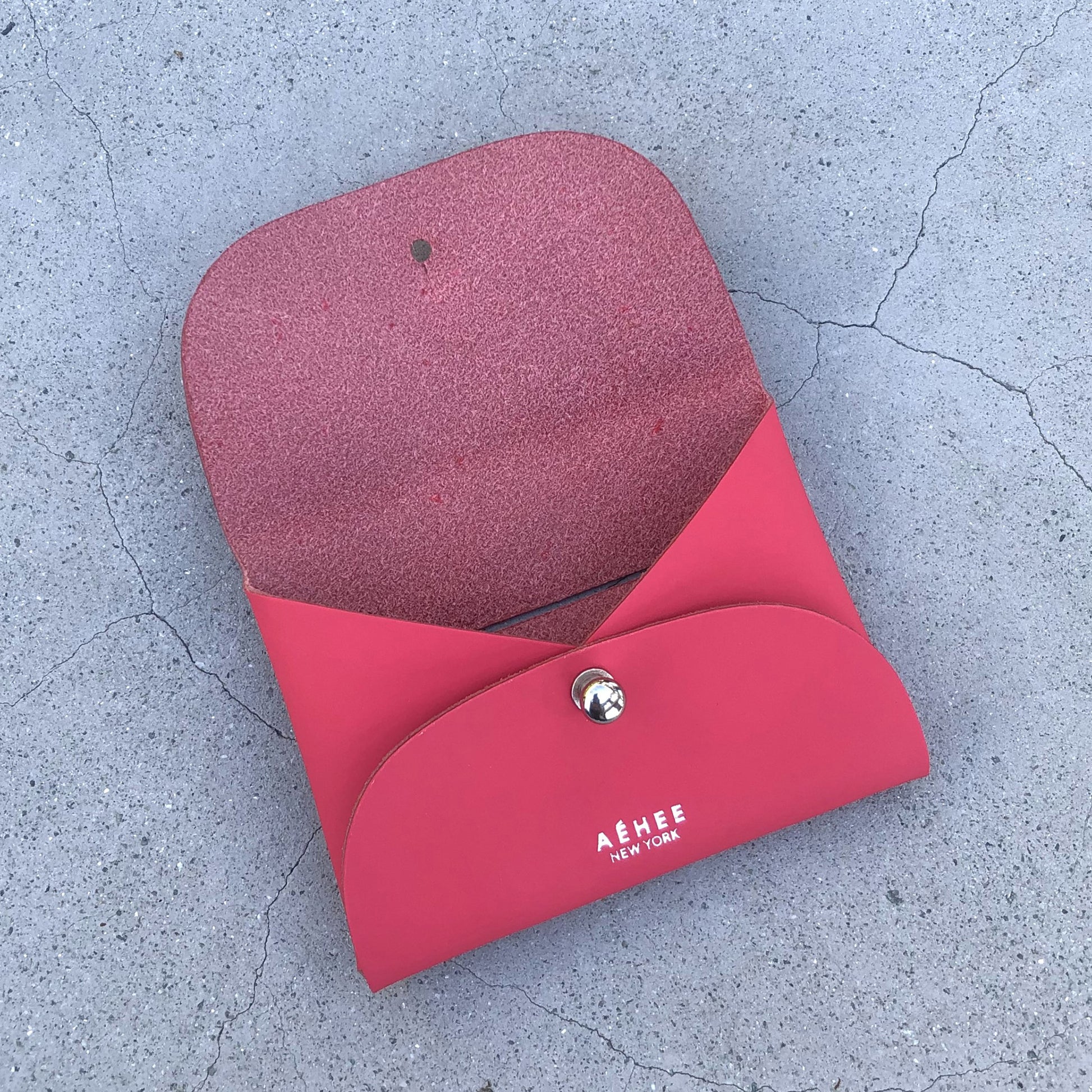 Chic red cardholder wallet crafted from Italian vegetable tanned leather for a minimal yet sophisticated look.