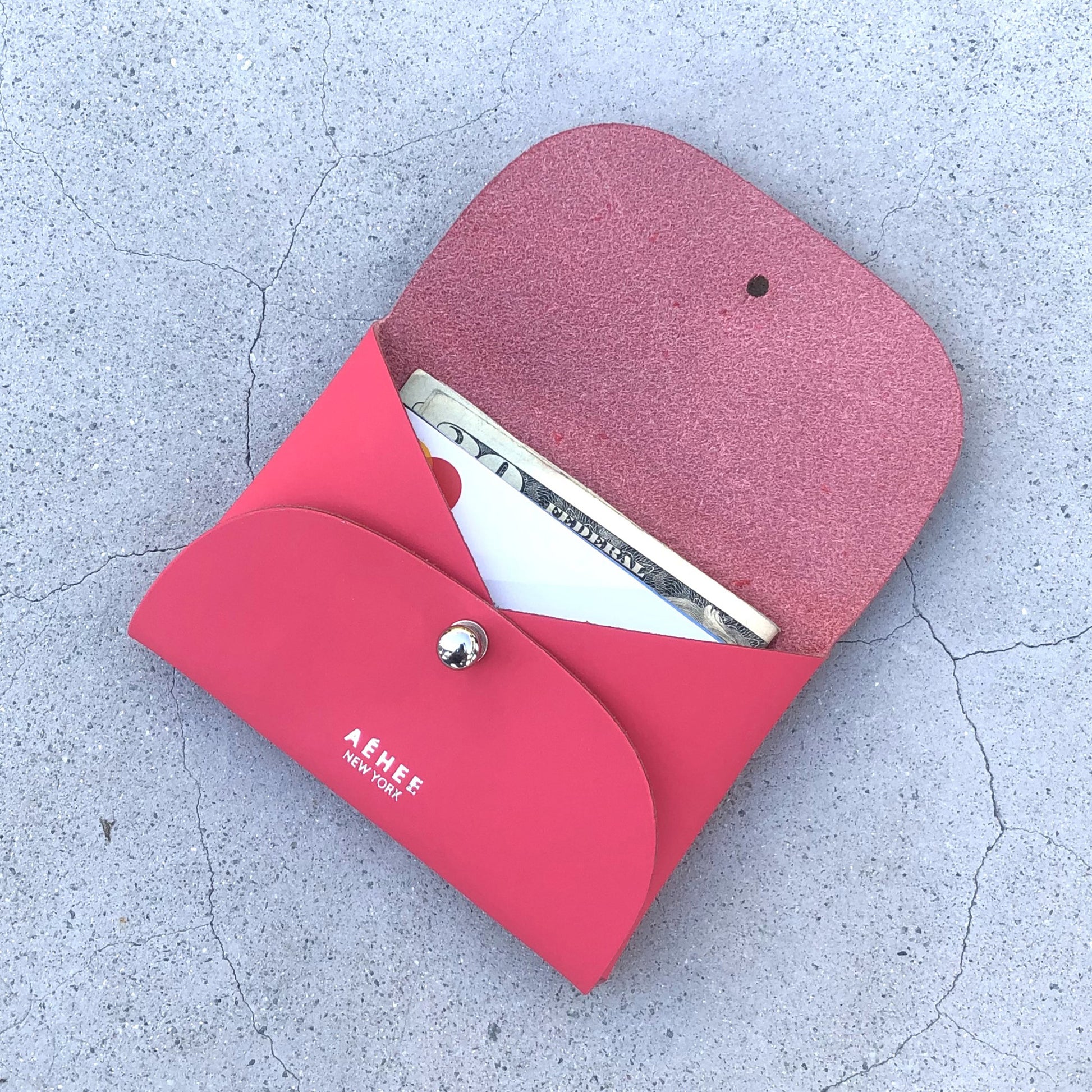 Chic red cardholder wallet crafted from Italian vegetable tanned leather for a minimal yet sophisticated look.