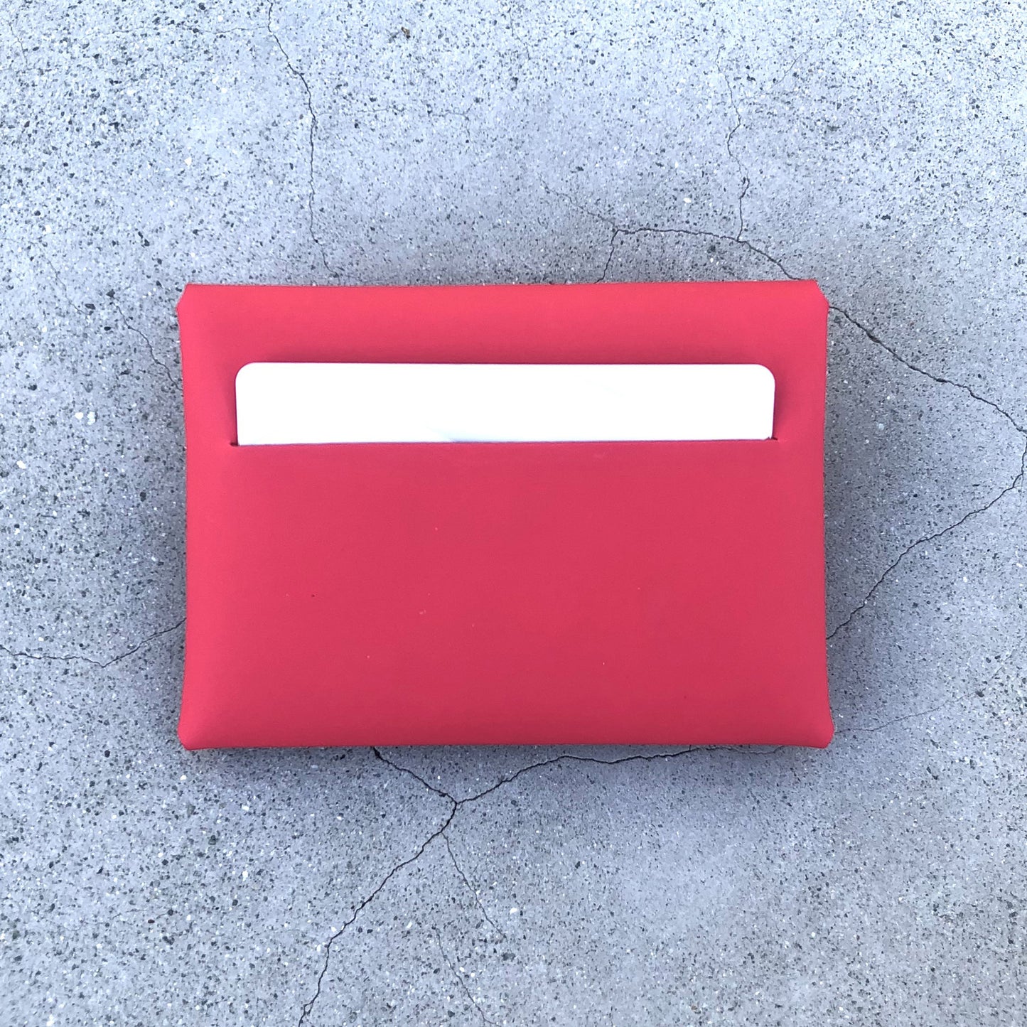 Chic red cardholder wallet crafted from Italian vegetable tanned leather for a minimal yet sophisticated look.