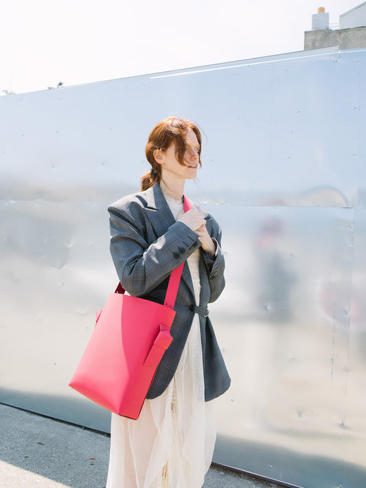 Chic red tote and bucket bag crafted from Italian vegetable tanned leather for a minimal yet sophisticated look.