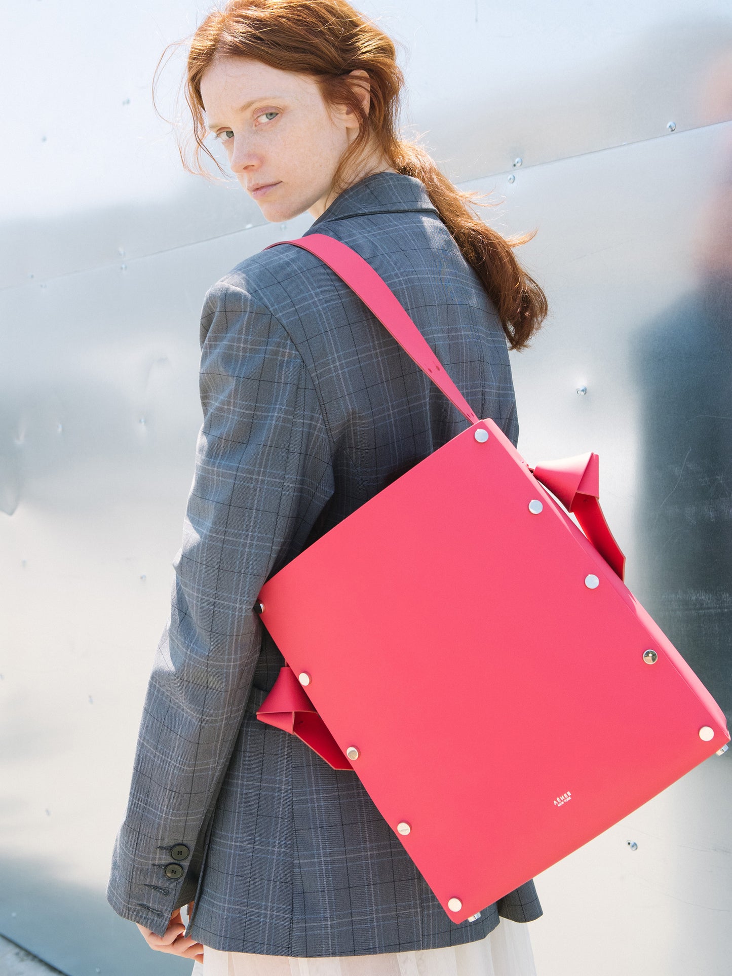 Chic red tote and bucket bag crafted from Italian vegetable tanned leather for a minimal yet sophisticated look.
