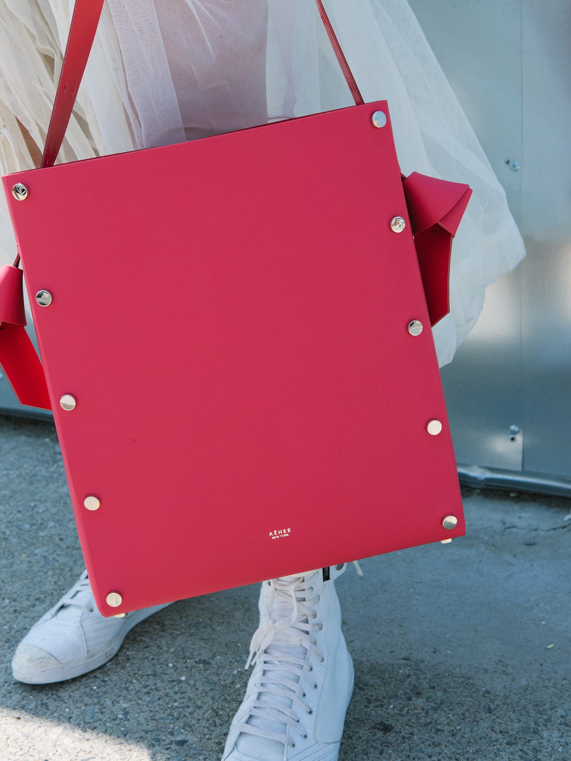 Chic red tote and bucket bag crafted from Italian vegetable tanned leather for a minimal yet sophisticated look.