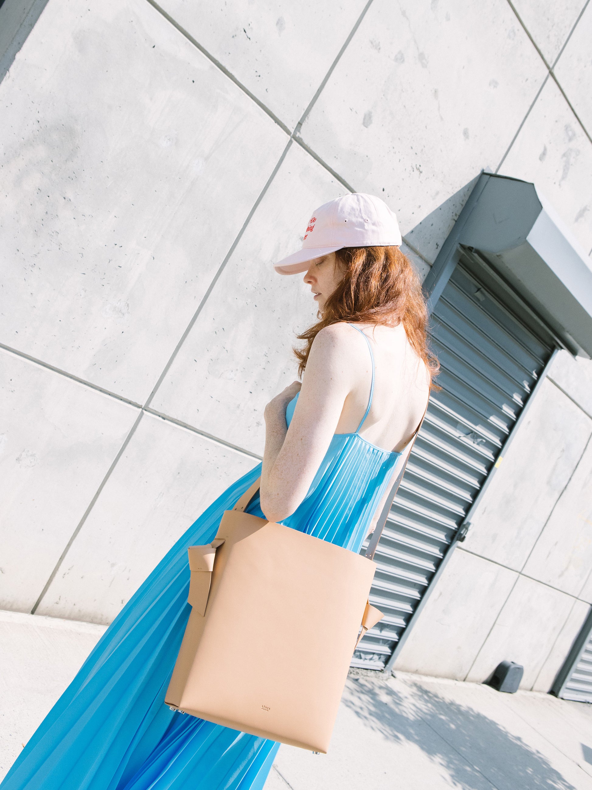 Chic beige tote and bucket bag crafted from Italian vegetable tanned leather for a minimal yet sophisticated look.