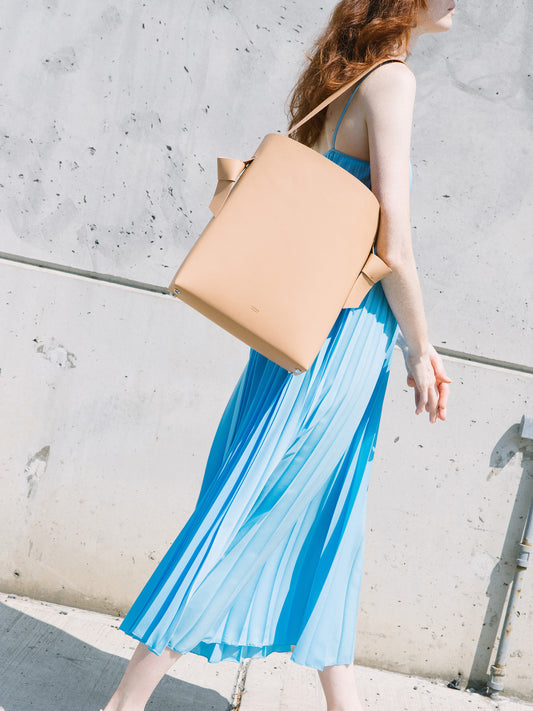 Chic beige tote and bucket bag crafted from Italian vegetable tanned leather for a minimal yet sophisticated look.