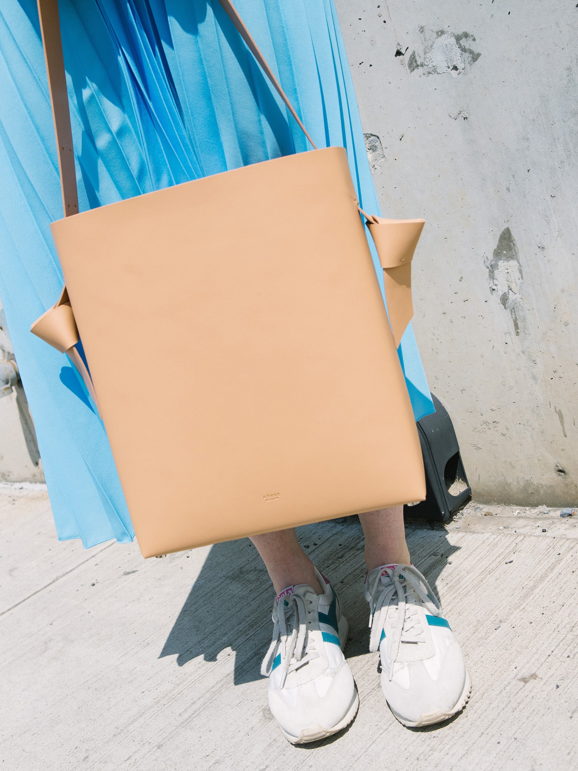Chic beige tote and bucket bag crafted from Italian vegetable tanned leather for a minimal yet sophisticated look.