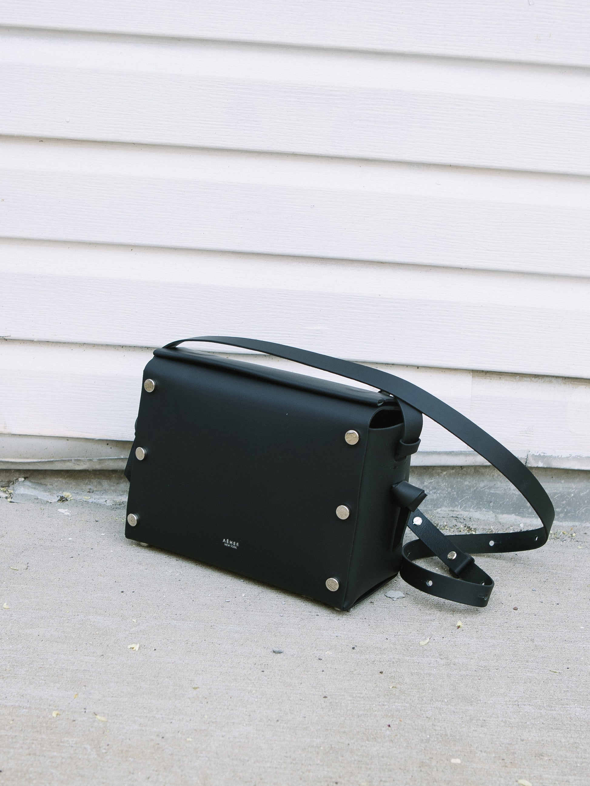 Chic black crossbody bag and shoulder bag with adjustable strap crafted from Italian vegetable tanned leather for a minimal yet sophisticated look.