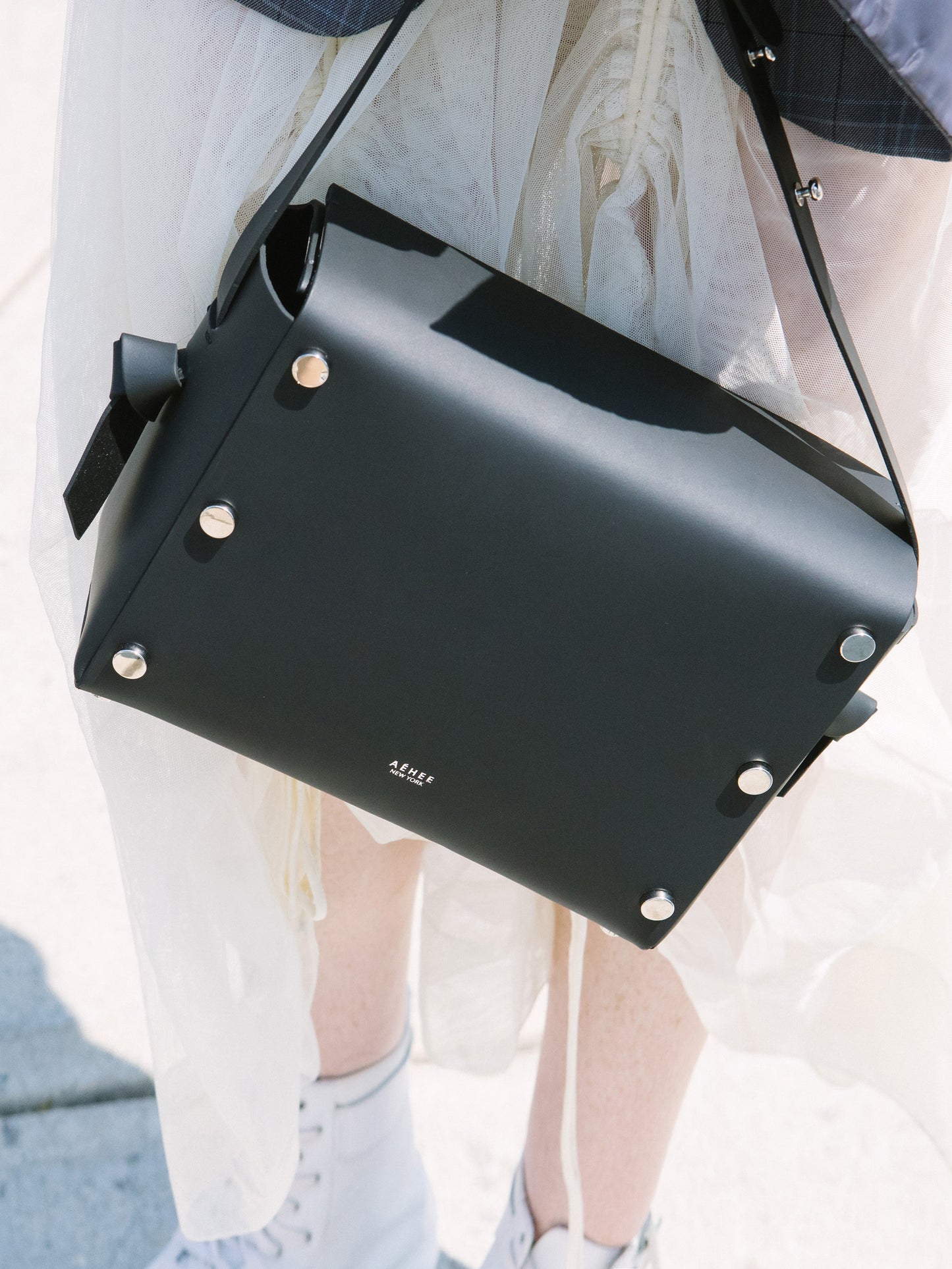 Chic black crossbody bag and shoulder bag with adjustable strap crafted from Italian vegetable tanned leather for a minimal yet sophisticated look.