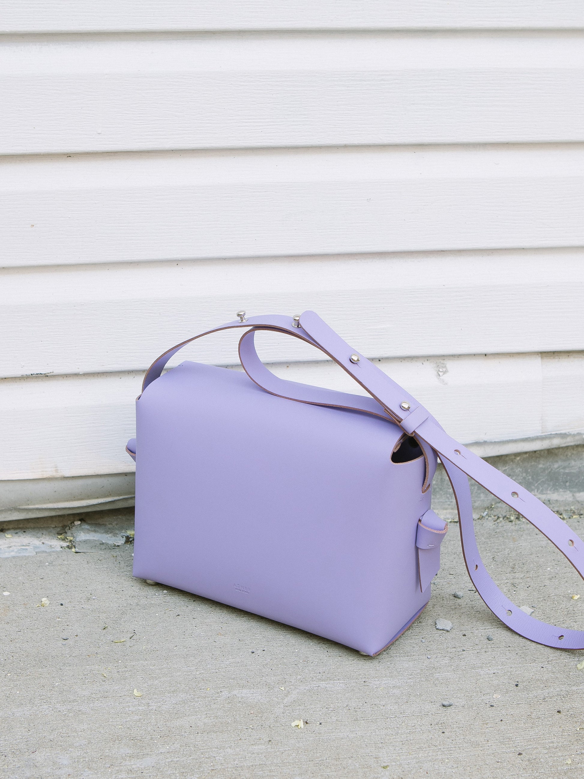 Chic lavender crossbody bag and shoulder bag with adjustable strap crafted from Italian vegetable tanned leather for a minimal yet sophisticated look.