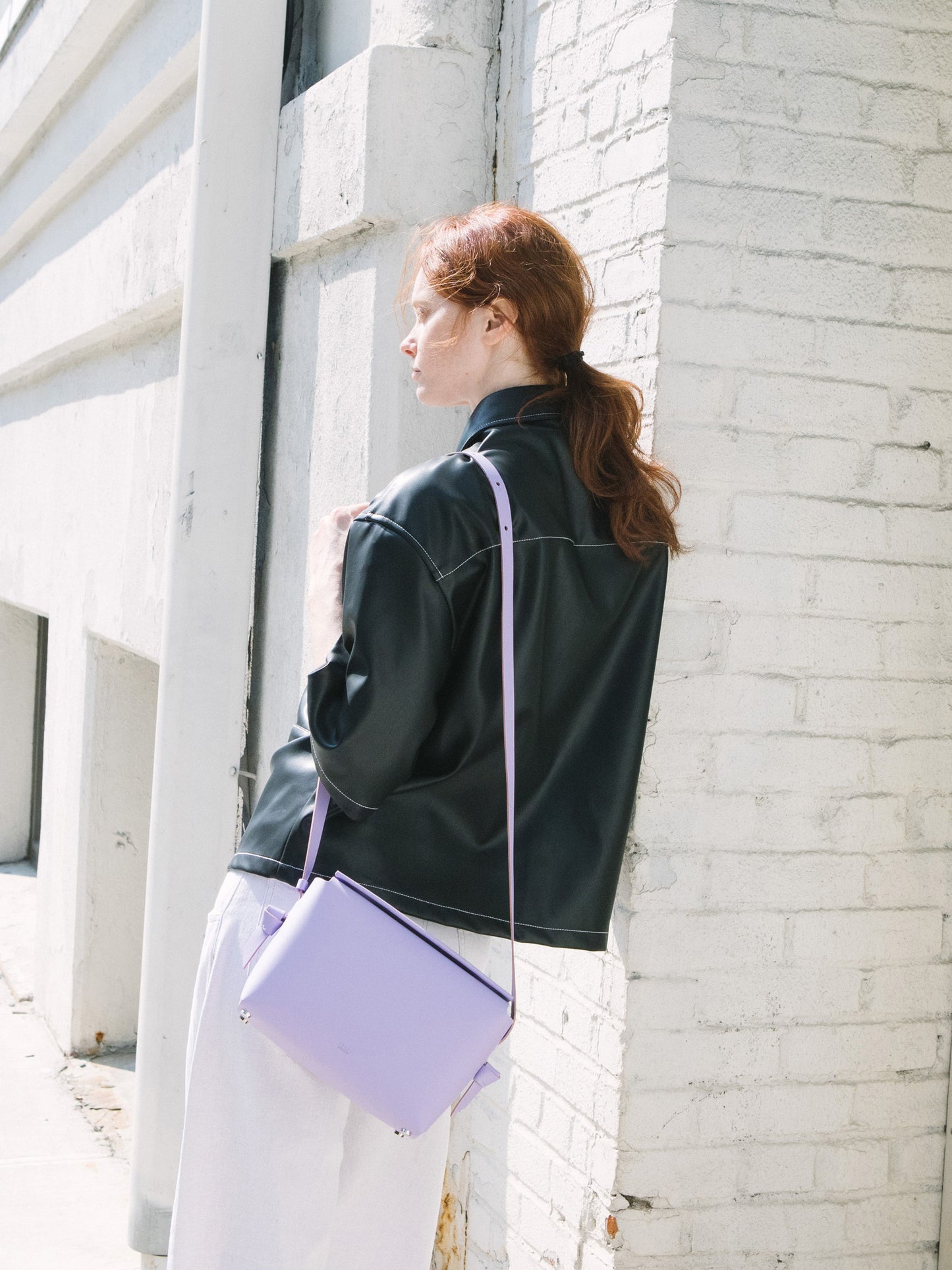 Chic lavender crossbody bag and shoulder bag with adjustable strap crafted from Italian vegetable tanned leather for a minimal yet sophisticated look.