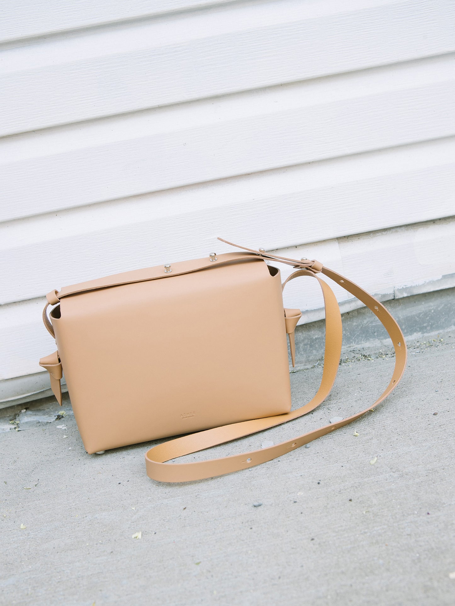 Chic beige crossbody bag and shoulder bag with adjustable strap crafted from Italian vegetable tanned leather for a minimal yet sophisticated look.