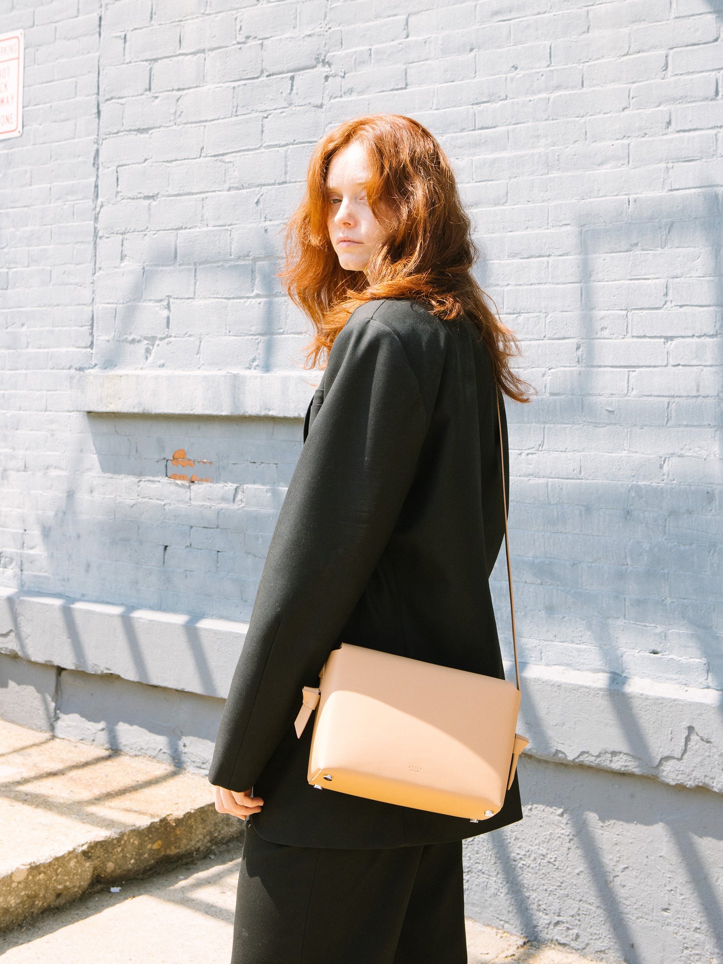 Chic beige crossbody bag and shoulder bag with adjustable strap crafted from Italian vegetable tanned leather for a minimal yet sophisticated look.