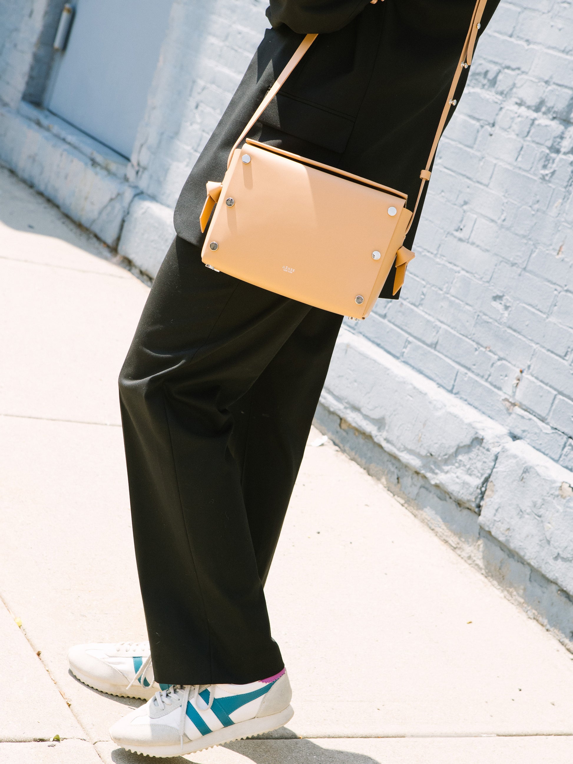 Chic beige crossbody bag and shoulder bag with adjustable strap crafted from Italian vegetable tanned leather for a minimal yet sophisticated look.