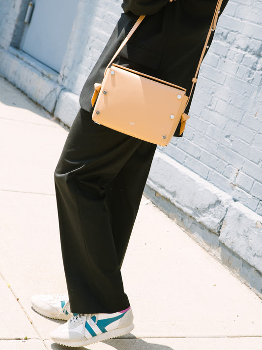 Chic beige crossbody bag and shoulder bag with adjustable strap crafted from Italian vegetable tanned leather for a minimal yet sophisticated look.