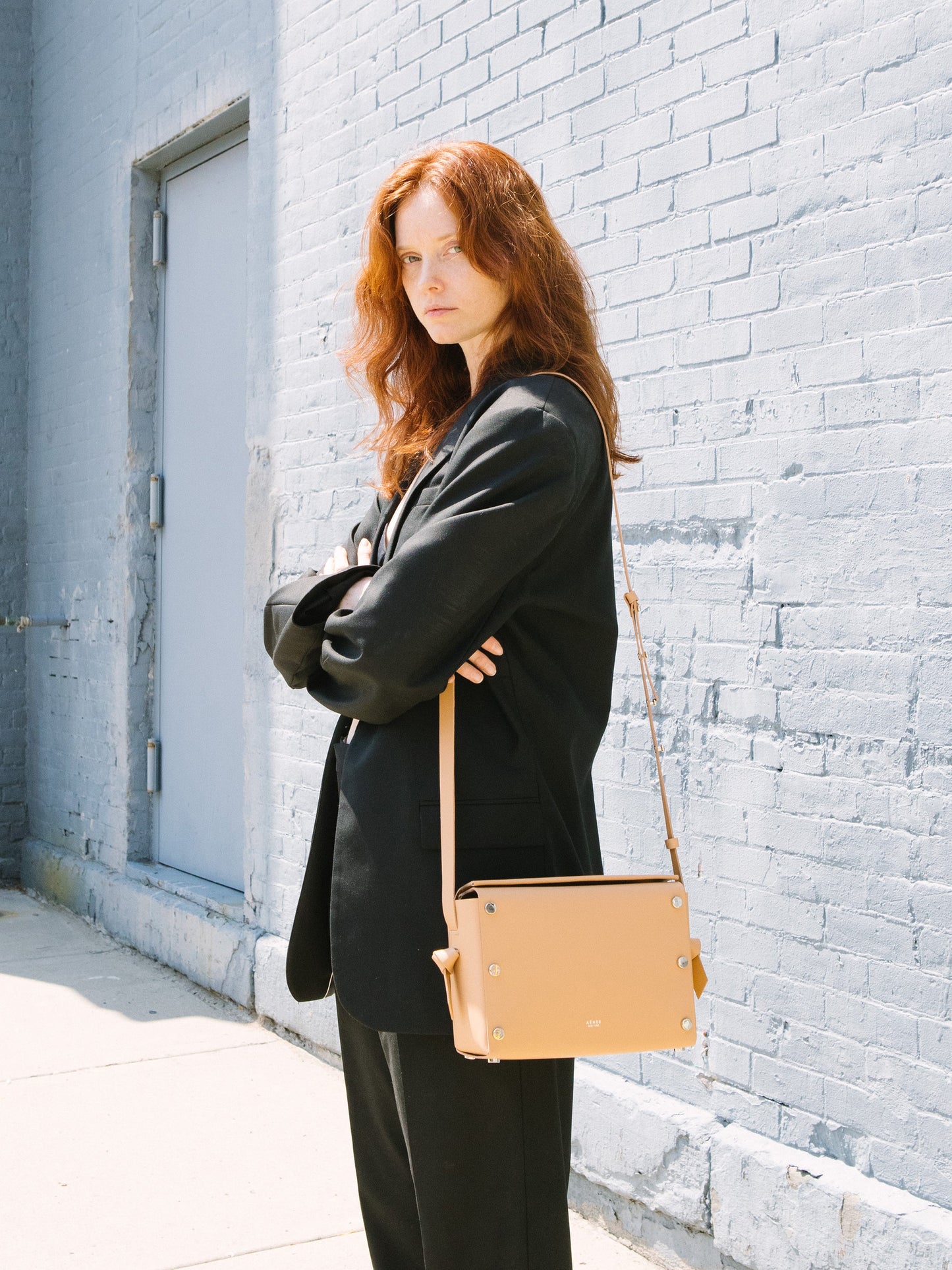 Chic beige crossbody bag and shoulder bag with adjustable strap crafted from Italian vegetable tanned leather for a minimal yet sophisticated look.