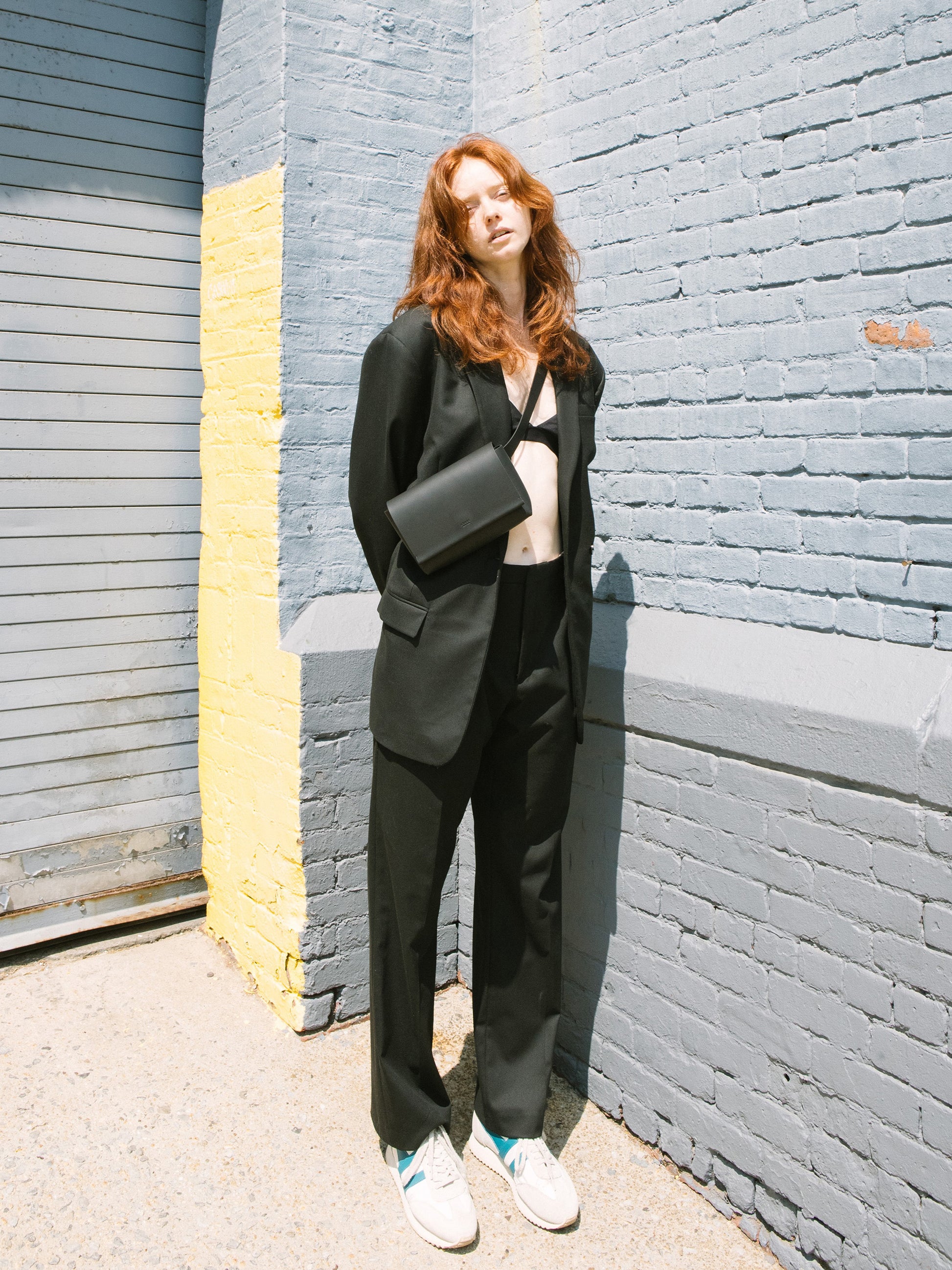 Chic black designer belt bag and fanny pack crafted from Italian vegetable tanned leather for a minimalist yet sophisticated look.