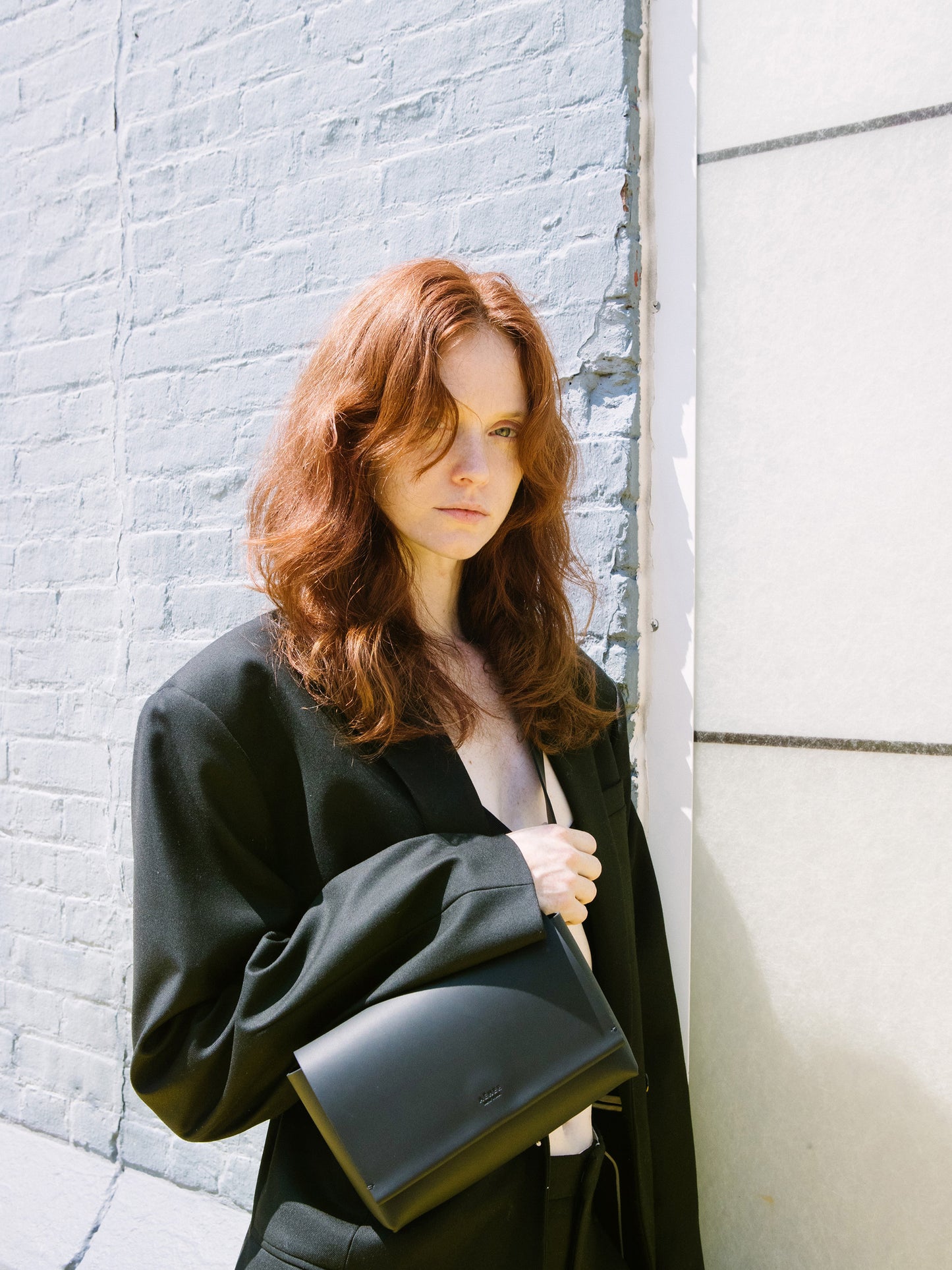 Chic black designer belt bag and fanny pack crafted from Italian vegetable tanned leather for a minimalist yet sophisticated look.