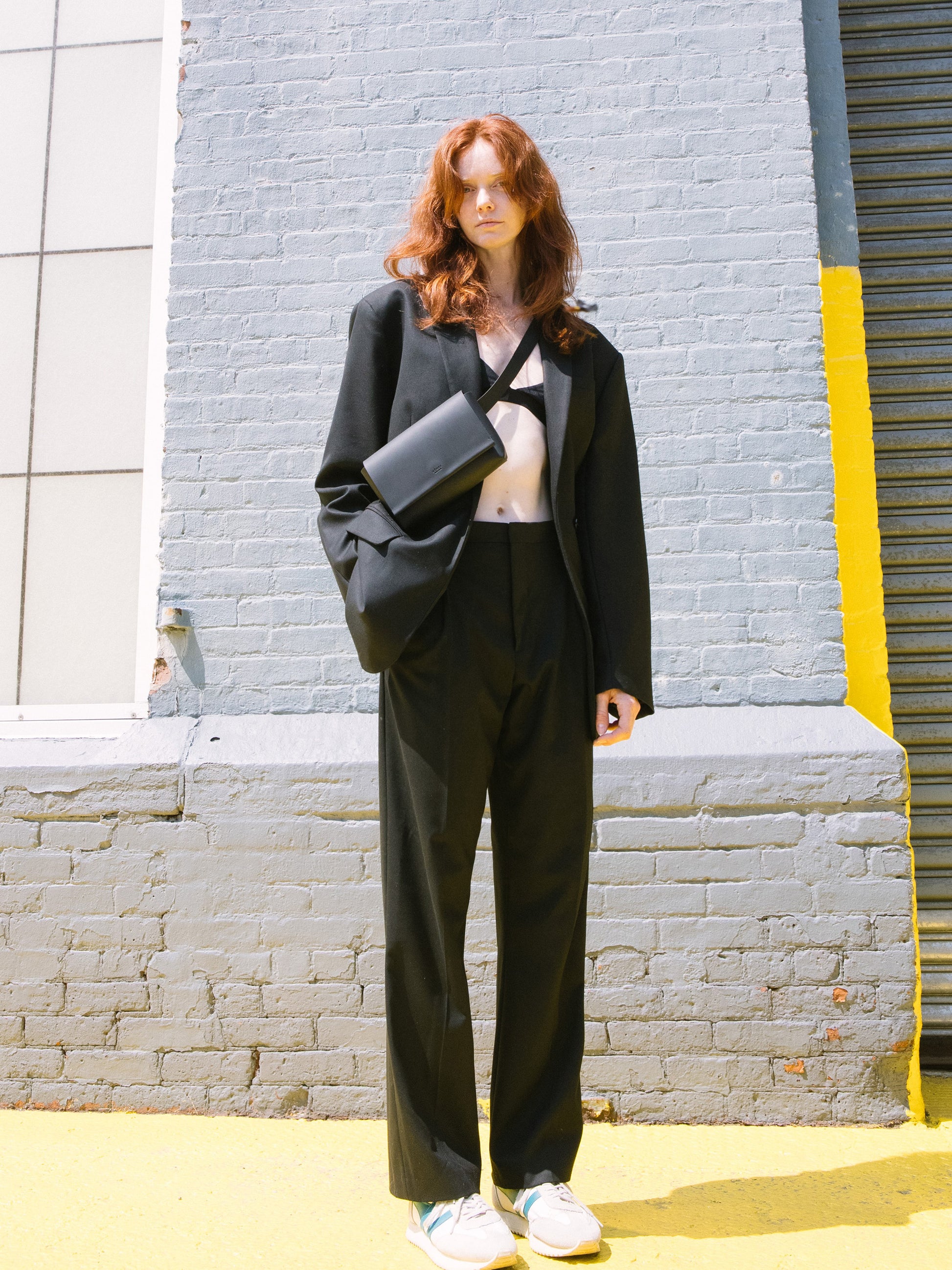 Chic black designer belt bag and fanny pack crafted from Italian vegetable tanned leather for a minimalist yet sophisticated look.