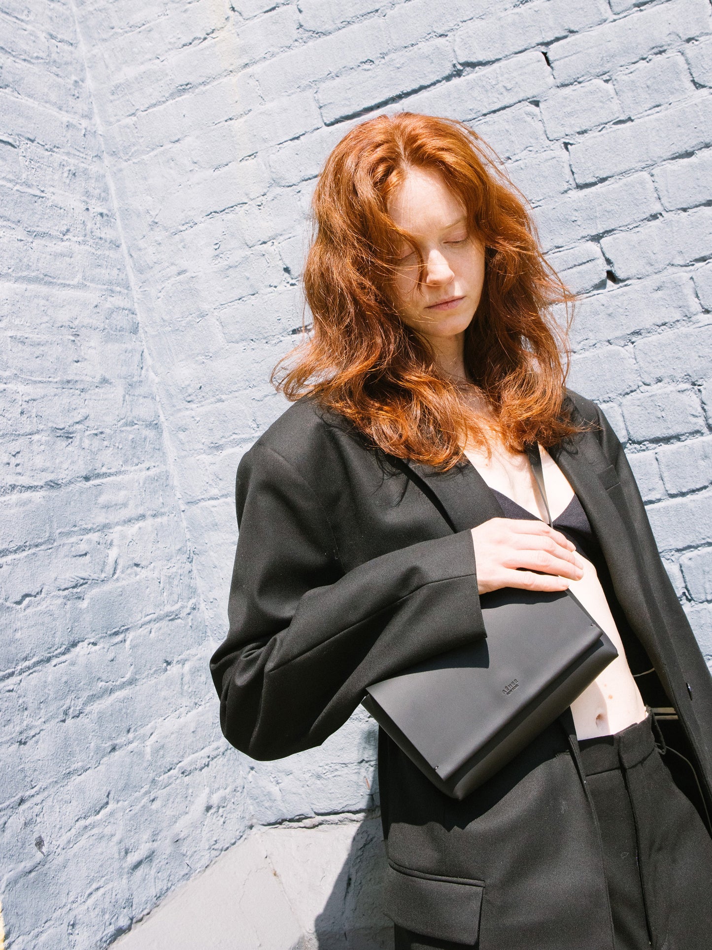 Chic black designer belt bag and fanny pack crafted from Italian vegetable tanned leather for a minimalist yet sophisticated look.