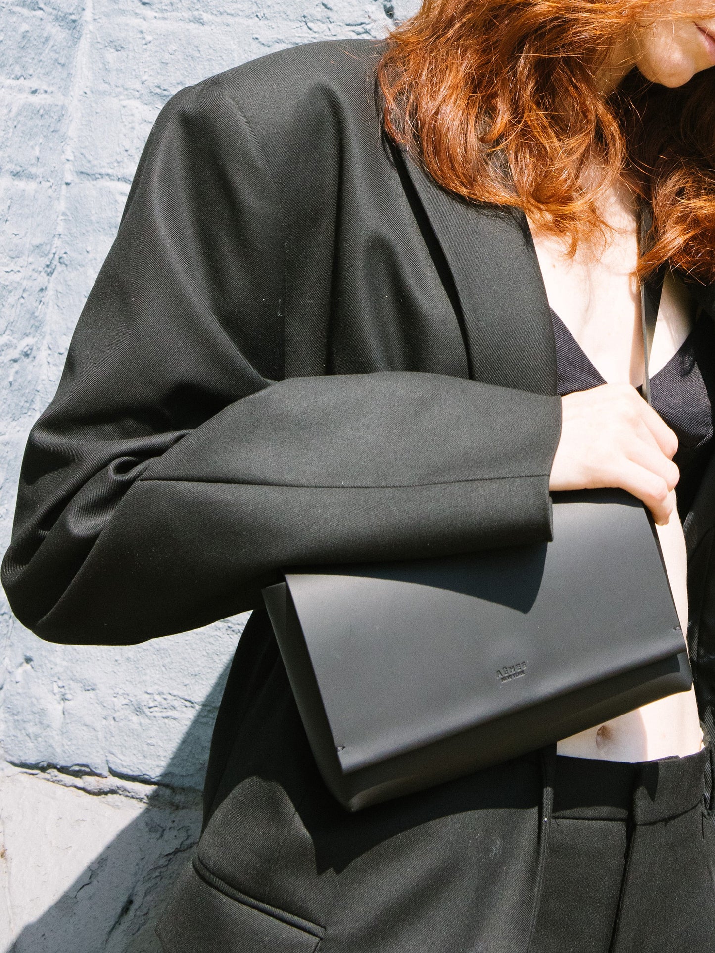 Chic black designer belt bag and fanny pack crafted from Italian vegetable tanned leather for a minimalist yet sophisticated look.