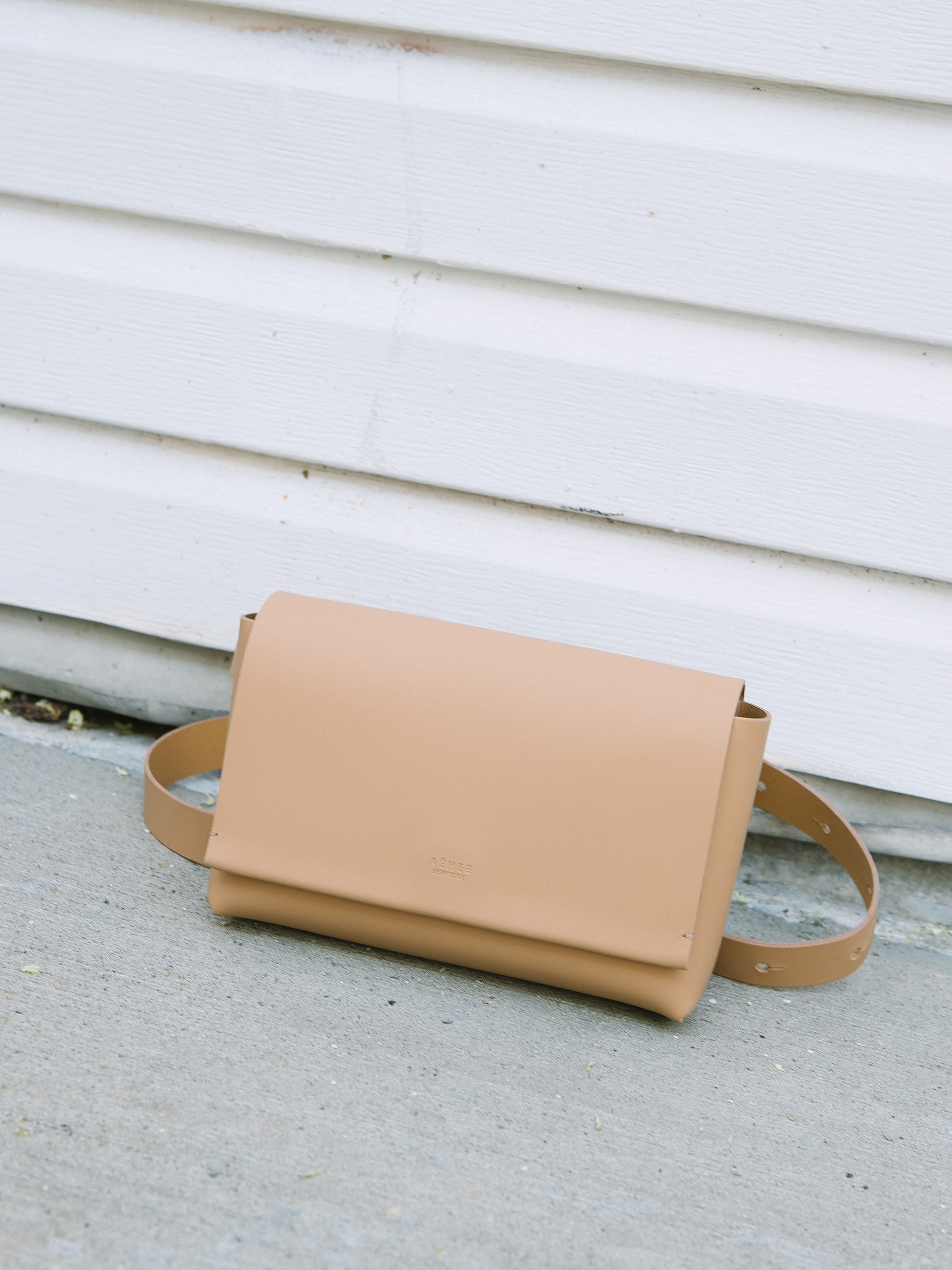 Chic beige designer belt bag and fanny pack crafted from Italian vegetable tanned leather for a minimalist yet sophisticated look.