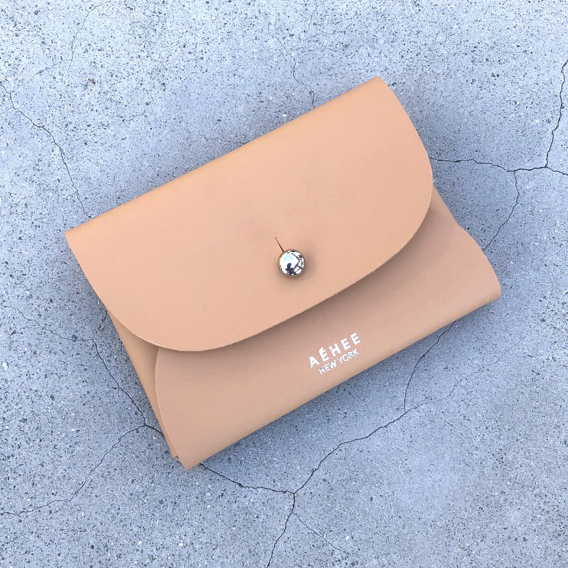 Chic beige cardholder wallet crafted from Italian vegetable tanned leather for a minimal yet sophisticated look.