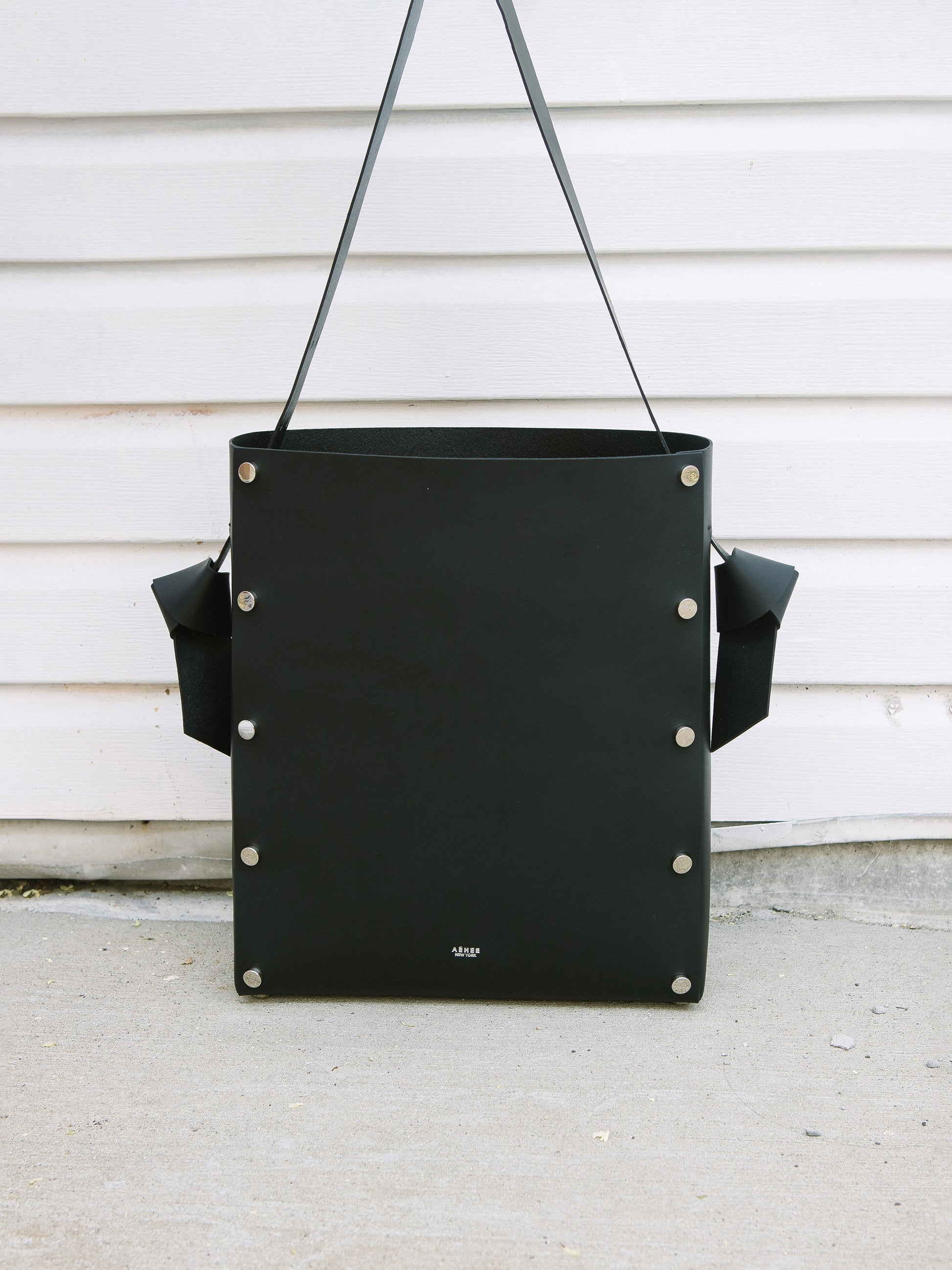 Chic black tote and bucket bag crafted from Italian vegetable tanned leather for a minimal yet sophisticated look.