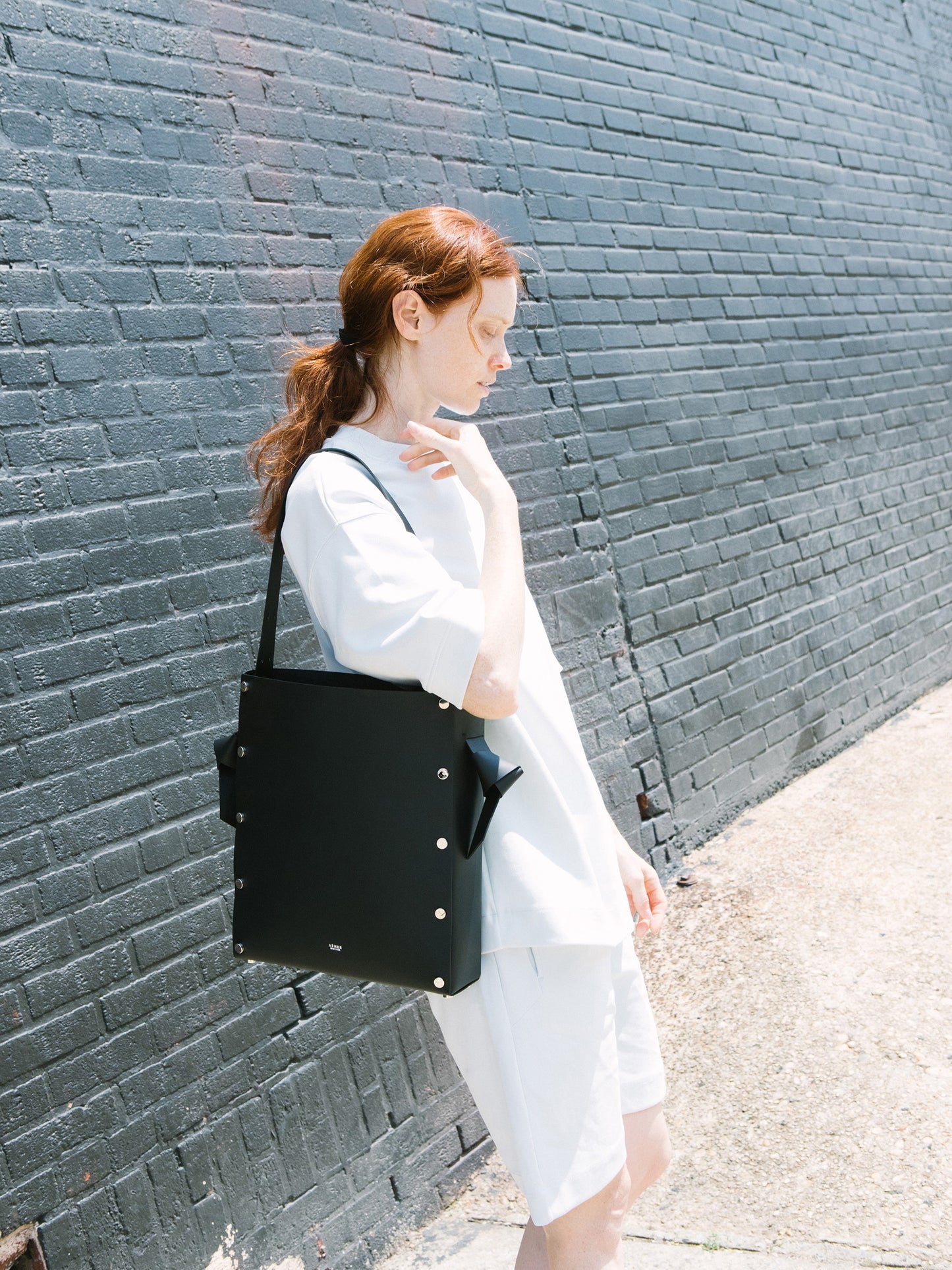 Chic black tote and bucket bag crafted from Italian vegetable tanned leather for a minimal yet sophisticated look.