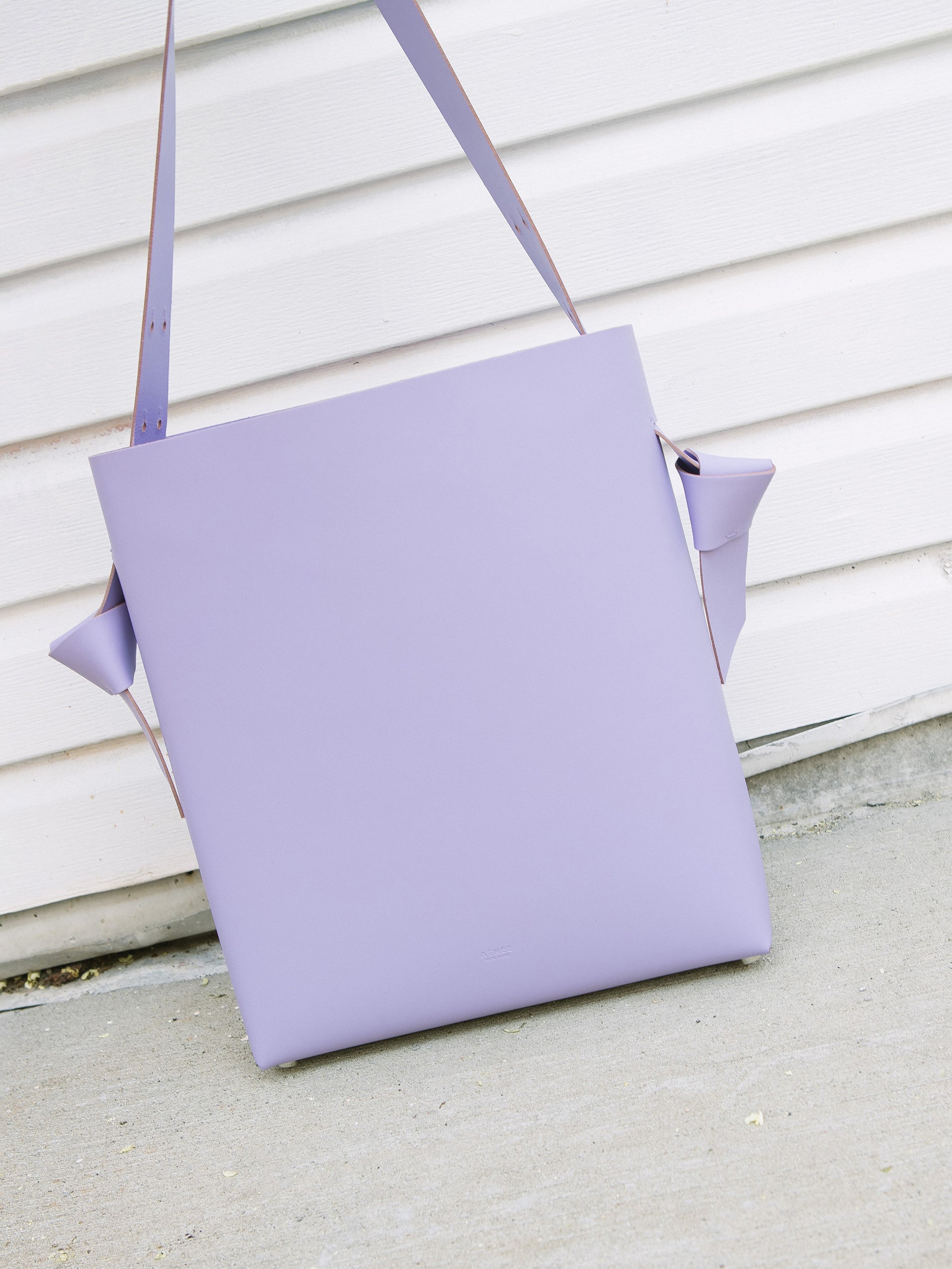 Chic lavender tote and bucket bag crafted from Italian vegetable tanned leather for a minimal yet sophisticated look.