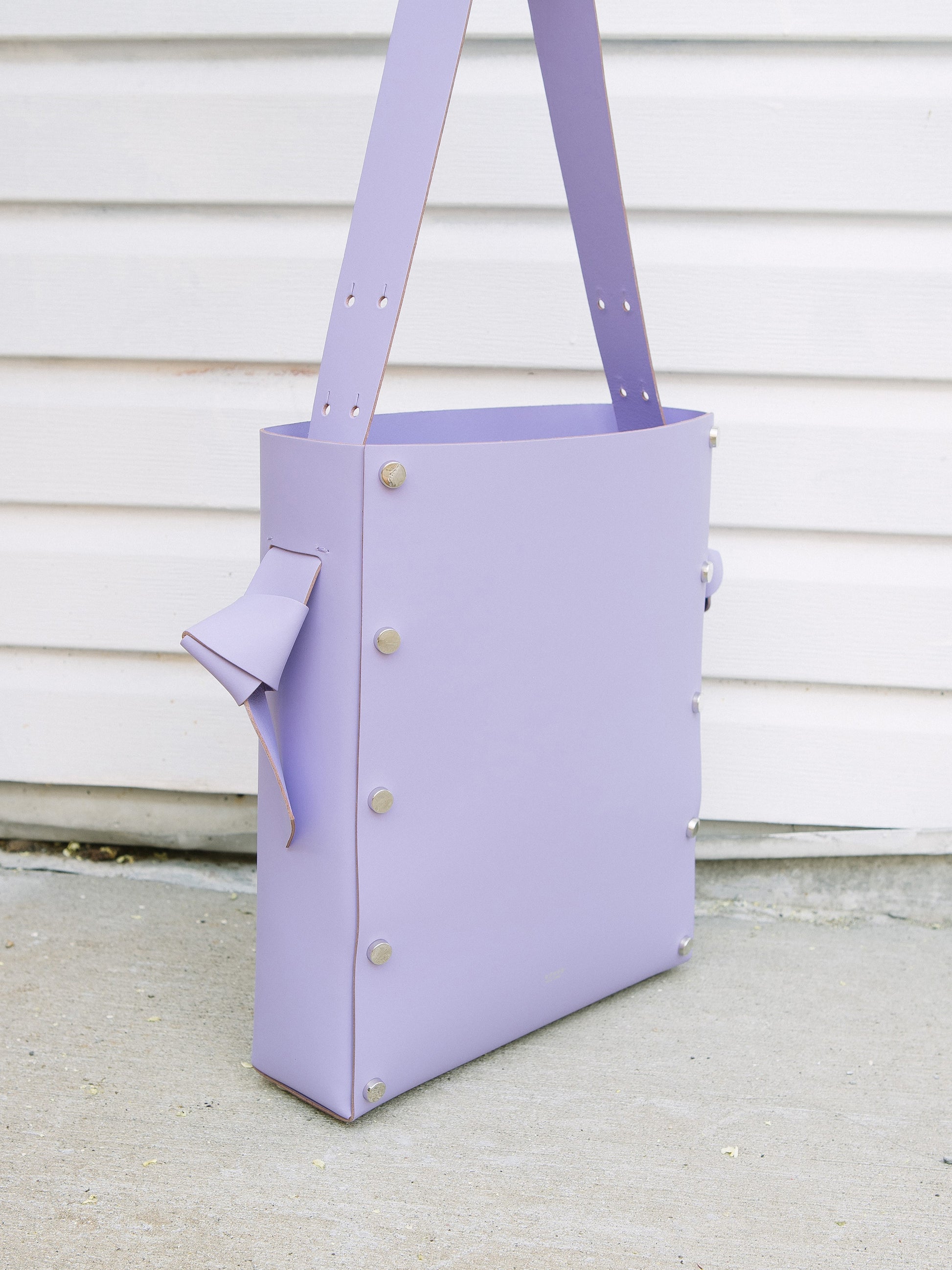 Chic lavender tote and bucket bag crafted from Italian vegetable tanned leather for a minimal yet sophisticated look.