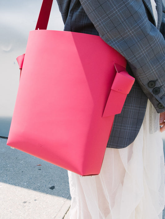Chic red tote and bucket bag crafted from Italian vegetable tanned leather for a minimal yet sophisticated look.