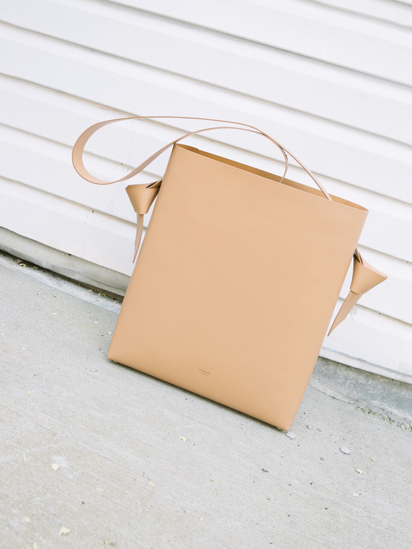 Chic beige tote and bucket bag crafted from Italian vegetable tanned leather for a minimal yet sophisticated look.