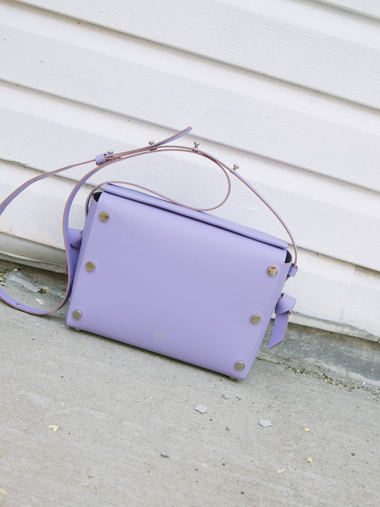 Chic lavender crossbody bag and shoulder bag with adjustable strap crafted from Italian vegetable tanned leather for a minimal yet sophisticated look.