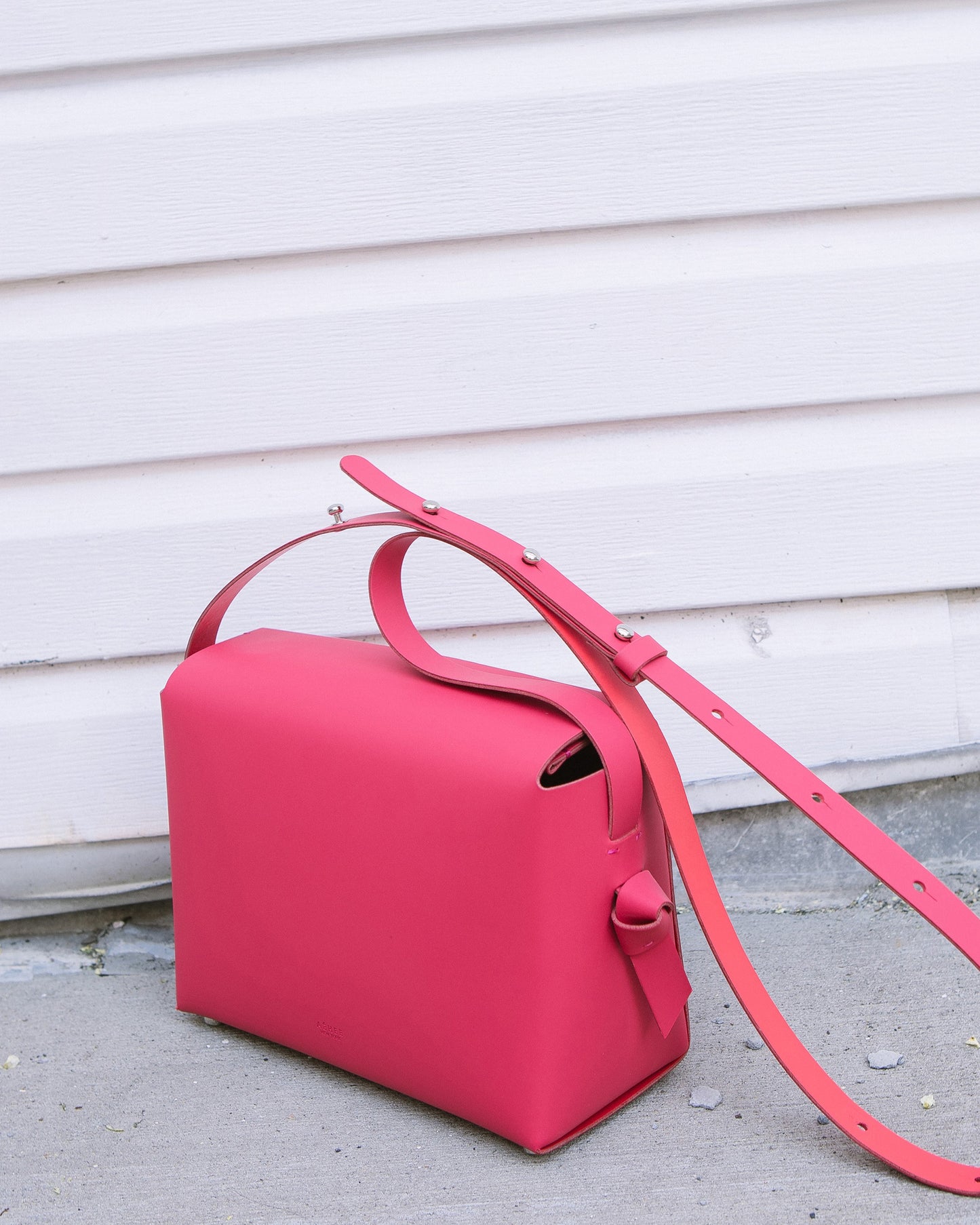 Chic red crossbody bag and shoulder bag with adjustable strap crafted from Italian vegetable tanned leather for a minimal yet sophisticated look.