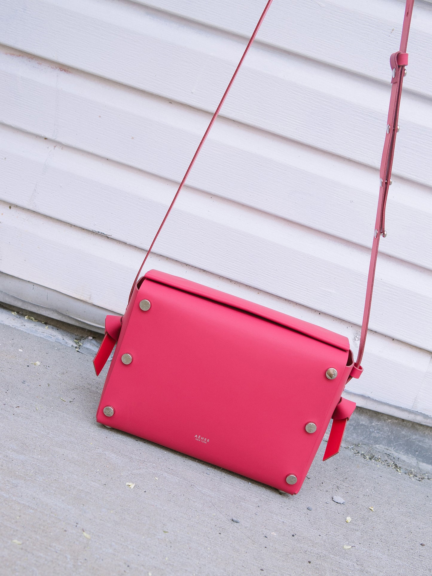 Chic red crossbody bag and shoulder bag with adjustable strap crafted from Italian vegetable tanned leather for a minimal yet sophisticated look.