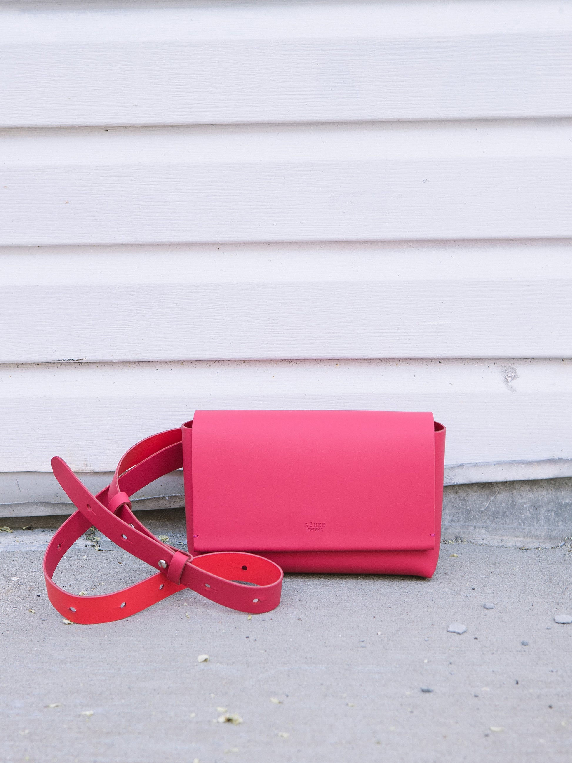 Chic red designer belt bag and fanny pack crafted from Italian vegetable tanned leather for a minimalist yet sophisticated look.
